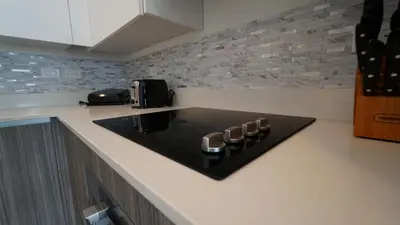 a kitchen with a counter top with a stove at Sleek New Brickell Condo With Free Parking - CS65 in Miami