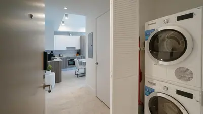 a laundry room with a washer and dryer next to a kitchen at Sleek New Brickell Condo With Free Parking - CS65 in Miami