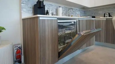 a kitchen with a counter with a slide at Sleek New Brickell Condo With Free Parking - CS65 in Miami