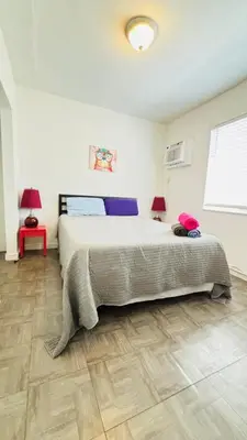 a bedroom with a large bed in a room at Apt 202 Near Cruise Port, 5 Min to Downtown, 4 Min to Trains, 14Min to Airp in Miami