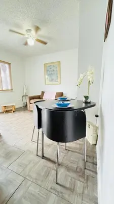a living room with a table and a couch at Apt 202 Near Cruise Port, 5 Min to Downtown, 4 Min to Trains, 14Min to Airp in Miami