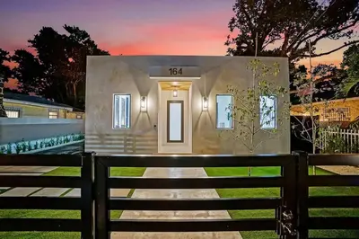 a small house with a fence in front of it at NEW Bali Resort Style Villa with Vast Pool & Jacuzzi and Outdoor Grilling in Miami
