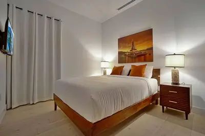 a bedroom with a bed and a painting on the wall at NEW Bali Resort Style Villa with Vast Pool & Jacuzzi and Outdoor Grilling in Miami
