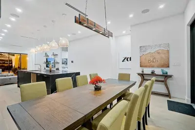 a dining room with a wooden table and chairs at NEW Bali Resort Style Villa with Vast Pool & Jacuzzi and Outdoor Grilling in Miami
