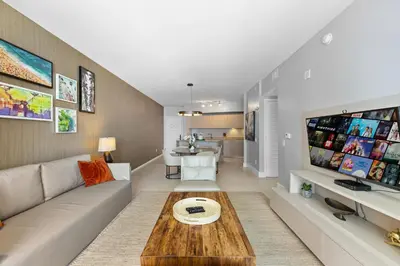 a living room with a couch and a table at Seaside Splendor! Modern Condo with Ocean View in Hollywood