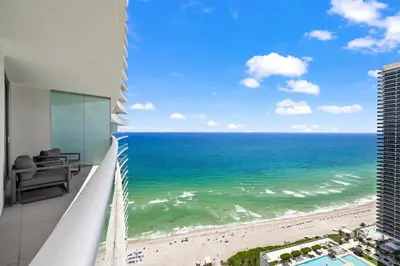a view of the ocean from the balcony of a building at Seaside Splendor! Modern Condo with Ocean View in Hollywood