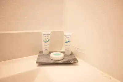 a bathroom with two bottles of sunscreen on a bath tub at Cozy Central Stay Airport, KingBed, Fenced Parking - Little Havana Near Airport, Wynwood, Calle 8 Brickell, Coral Gables and more in Miami