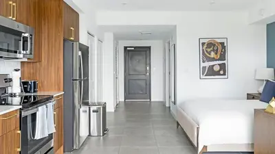 a small kitchen with a bed in a room at The Logan I in Miami