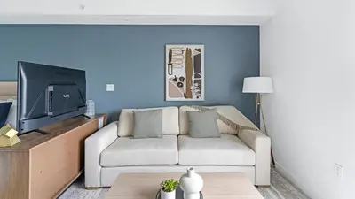 a living room with a couch and a tv at The Logan I in Miami