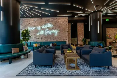 a lobby with blue furniture and a brick wall at The Bayfront VII in Miami