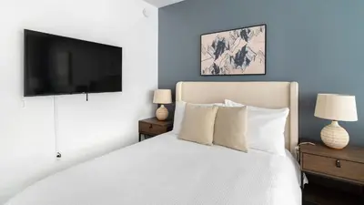 a bedroom with a white bed and a flat screen tv at The Bayfront VIII in Miami
