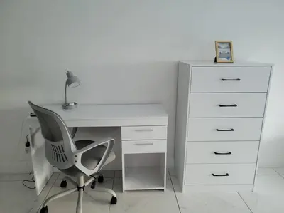a white desk with a chair and a dresser at Modern 1 BR Condo, Steps from Beach, Free Parking! in Sunny Isles Beach