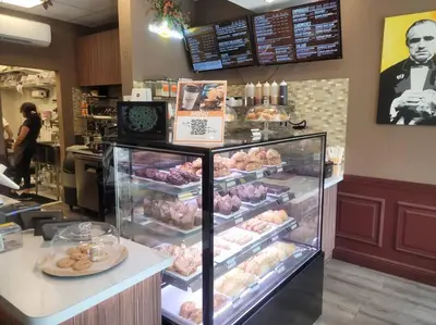 a bakery with a display case full of donuts at Modern 1 BR Condo, Steps from Beach, Free Parking! in Sunny Isles Beach