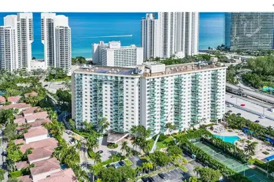 an aerial view of a large building in a city at Modern 1 BR Condo, Steps from Beach, Free Parking! in Sunny Isles Beach
