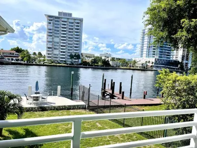 a view of a river with a dock and buildings at Renovated Intercoastal 2Bdrm 1 bath condo Walk to Beach in Fort Lauderdale