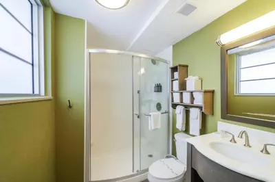 a bathroom with a shower and a sink at Claremont Hotel in Miami Beach