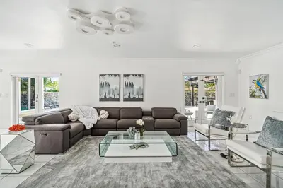 a living room with a couch and a table at Tropical Pool Paradise x 6-BD 4-BA Luxury Living in Hialeah