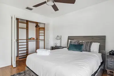 a bedroom with a large white bed with a ceiling fan at Tropical Pool Paradise x 6-BD 4-BA Luxury Living in Hialeah