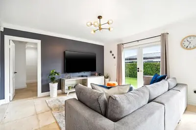 a living room with a couch and a tv at 6-BD 3-BA Dreamy Vacation Retreat in Coral Terrace in Miami