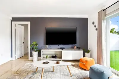 a living room with a flat screen tv on a wall at 6-BD 3-BA Dreamy Vacation Retreat in Coral Terrace in Miami
