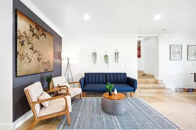 a living room with a blue couch and chairs at 6-BD 3-BA Dreamy Vacation Retreat in Coral Terrace in Miami