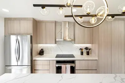a kitchen with a stainless steel refrigerator and a chandelier at 6-BD 3-BA Dreamy Vacation Retreat in Coral Terrace in Miami