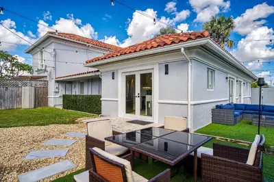 a house with a table and chairs in the yard at 6-BD 3-BA Dreamy Vacation Retreat in Coral Terrace in Miami