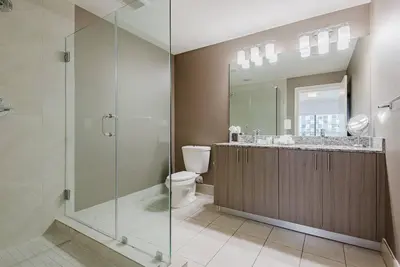 a bathroom with a glass shower and a toilet at Wonderful 2 bedroom Apartment in Downtown Doral in Miami