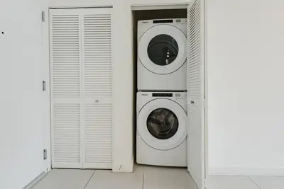 two washing machines and a washer and dryer in a room at Wonderful 2 bedroom Apartment in Downtown Doral in Miami