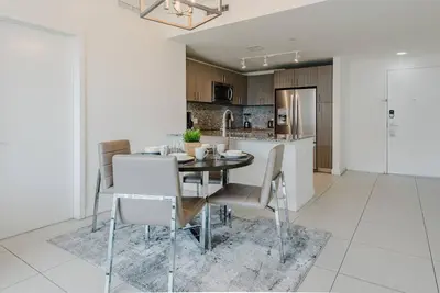 a dining room and kitchen with a table and chairs at Wonderful 2 bedroom Apartment in Downtown Doral in Miami