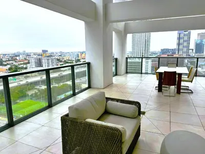 a living room with a couch and a table in a building at Private Terrace in Luxury 3BR Condo in Brickell in Miami