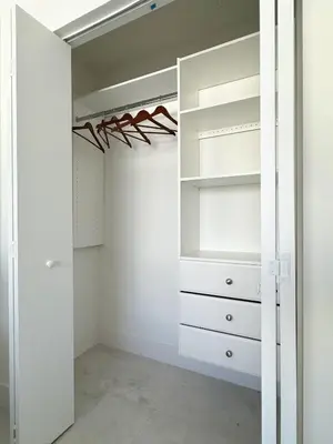 a walk in closet with white cabinets and a mirror at Private Terrace in Luxury 3BR Condo in Brickell in Miami