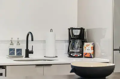 a kitchen counter with a coffee maker and a bowl at Roami at The Palace in Miami
