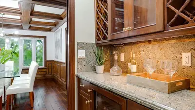 a kitchen with a sink and wine glasses on the counter at 5mins to Beach • Pool Hot Tub • Billiards Coral Ridge Getaway by AvantStay in Fort Lauderdale