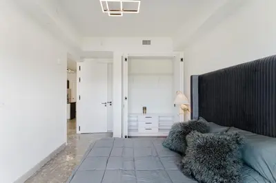 a bedroom with a large bed with pillows on it at Modern 2BR, Family-Friendly in FLL, Near Beach! in Fort Lauderdale