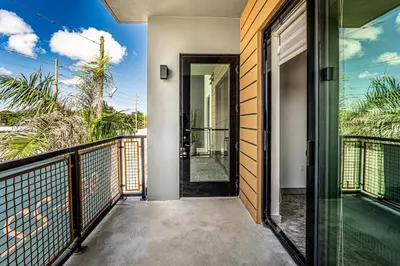 an open door to the balcony of a house at Prime 2BR by FLL Airport & Dania Beach Attractions in Fort Lauderdale