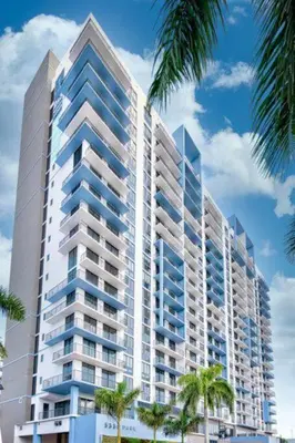 a tall building with palm trees in front of it at Wonderful Studio Apartment in Downtown Doral in Miami