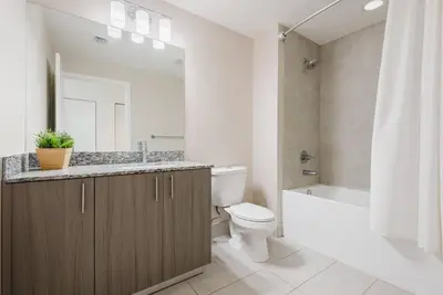 a bathroom with a sink and a toilet and a mirror at Wonderful Studio Apartment in Downtown Doral in Miami
