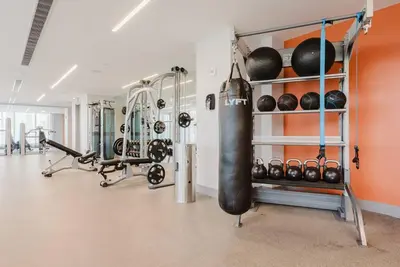 a fitness room with a gym with a punching bag and weights at Wonderful Studio Apartment in Downtown Doral in Miami