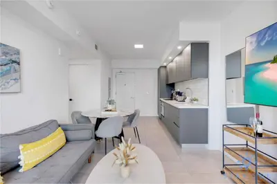 a living room with a couch and a table and a kitchen at Best Stay Gym Bar and Spa in Miami