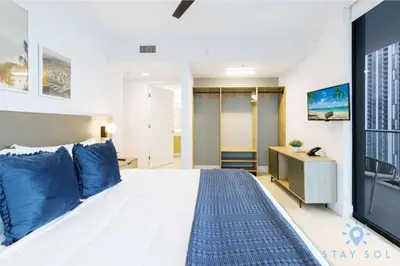 a bedroom with a large bed and a tv at Modern Apartment 2BR-2BTH- Pool & Gym in Miami