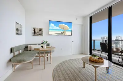 a living room with a table and chairs and a window at Spectacular Apartment with Pool & Gym in Miami