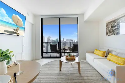 a living room with a white couch and a table at Spectacular Apartment with Pool & Gym in Miami