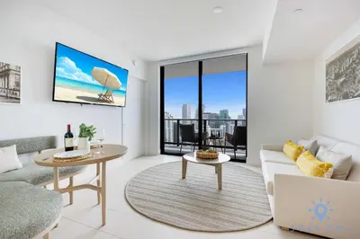 a living room with a couch and a table at Spectacular Apartment with Pool & Gym in Miami
