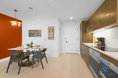 a kitchen with a table and chairs in a room at Chic Downtown - City Views Gym & Pool in Miami