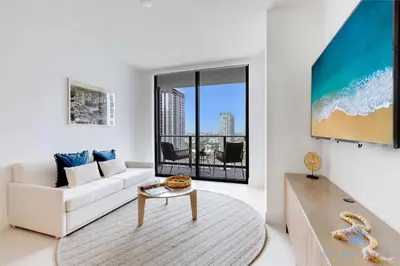 a living room with a white couch and a table at Oasis Apartment 1 Bedroom with Pool & Gym in Miami