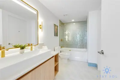 a bathroom with a tub and a toilet and a sink at Oasis Apartment 1 Bedroom with Pool & Gym in Miami