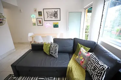 a black couch with pillows in a living room at Family Pet Friendly Apartment 3 Minute Walk to Miami Beach in Miami Beach