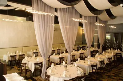 a dining room with white tables and chairs at Family Friendly Condo Steps to Miami Beach with Free Parking in Miami Beach