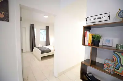 a bedroom with a bed and a book shelf at 3 Bedroom 3 Bathroom Miami Beach Apartment in Miami Beach